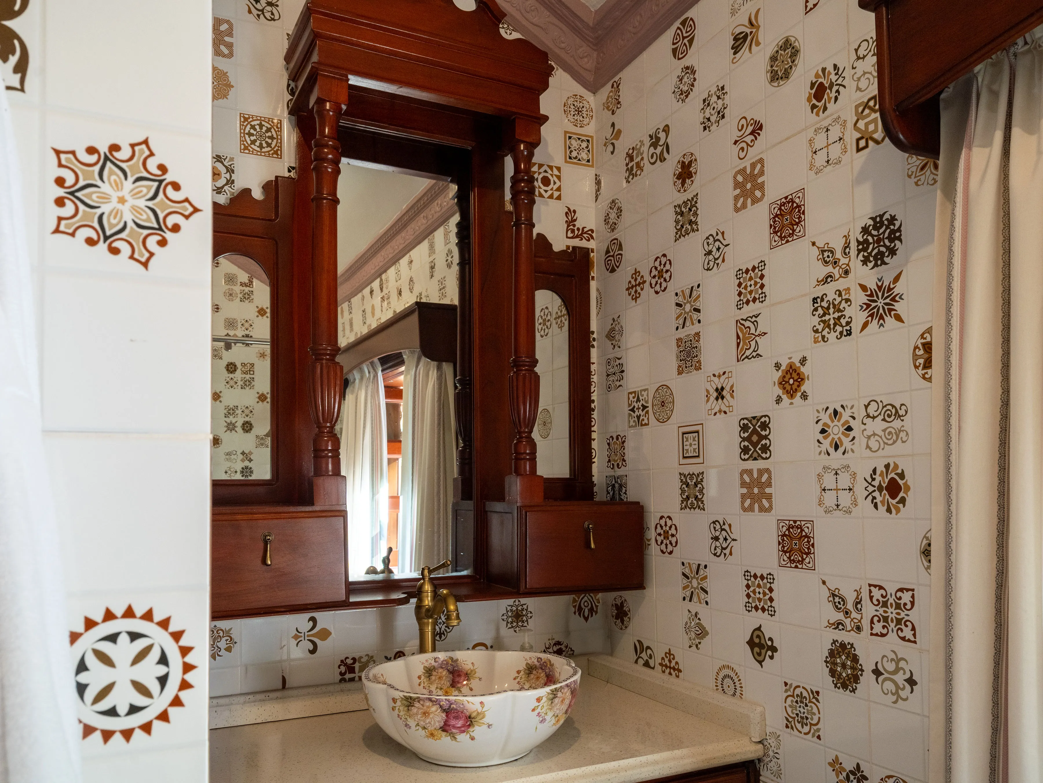 Brass faucet over a patterned vessel sink