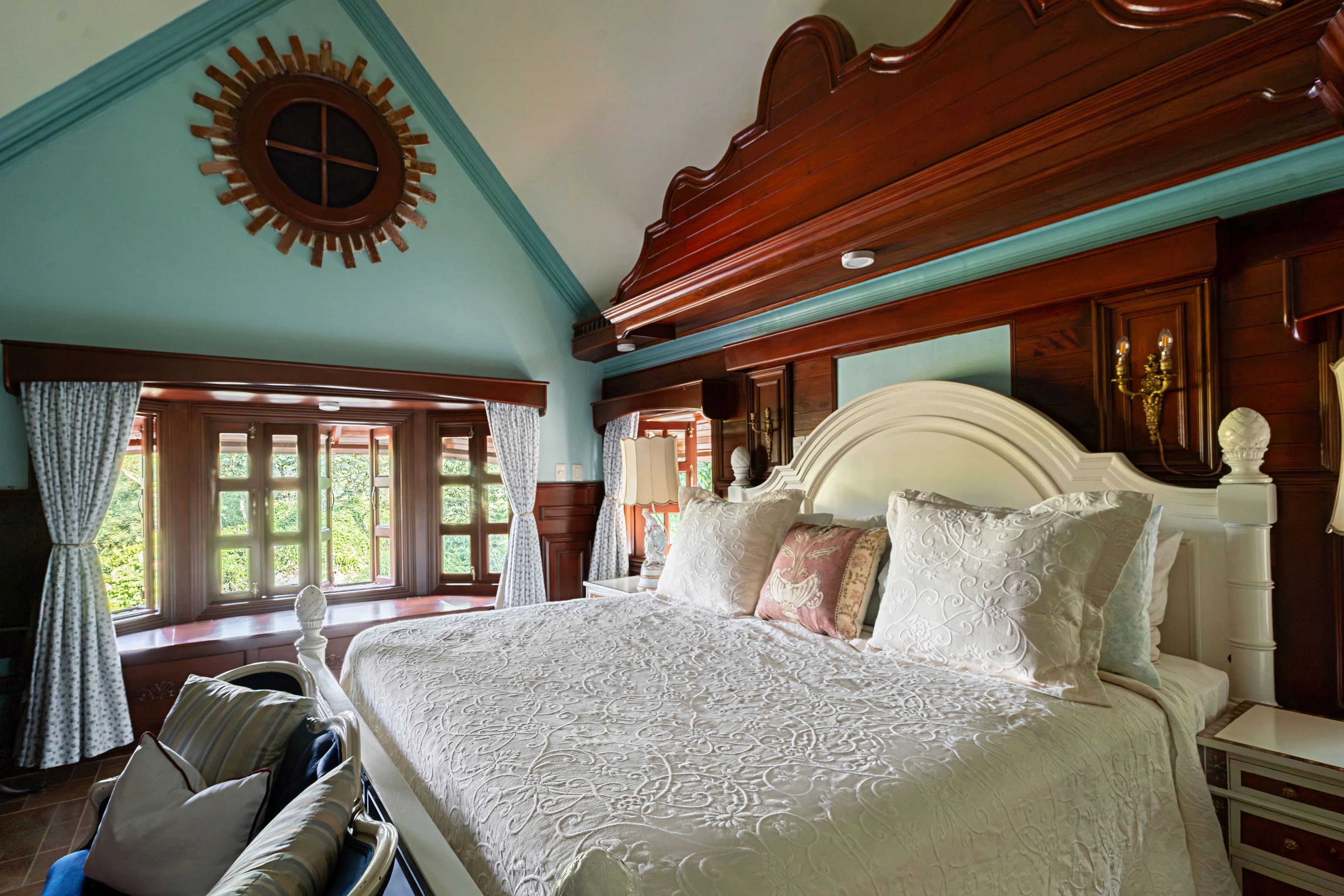 Primary bedroom with vaulted ceiling and mahogany headboard