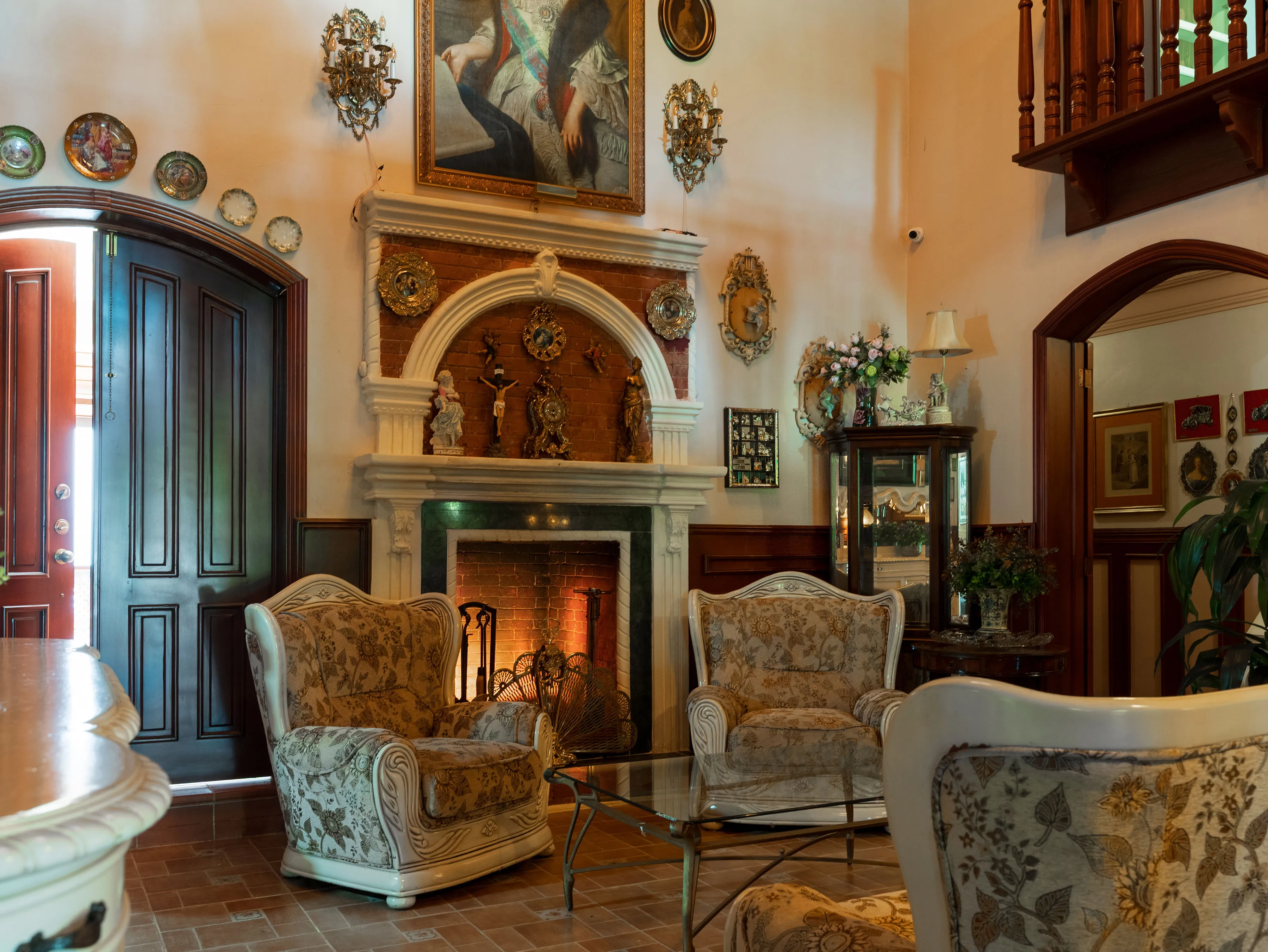 Brick fireplace surround framed by a carved white mantel