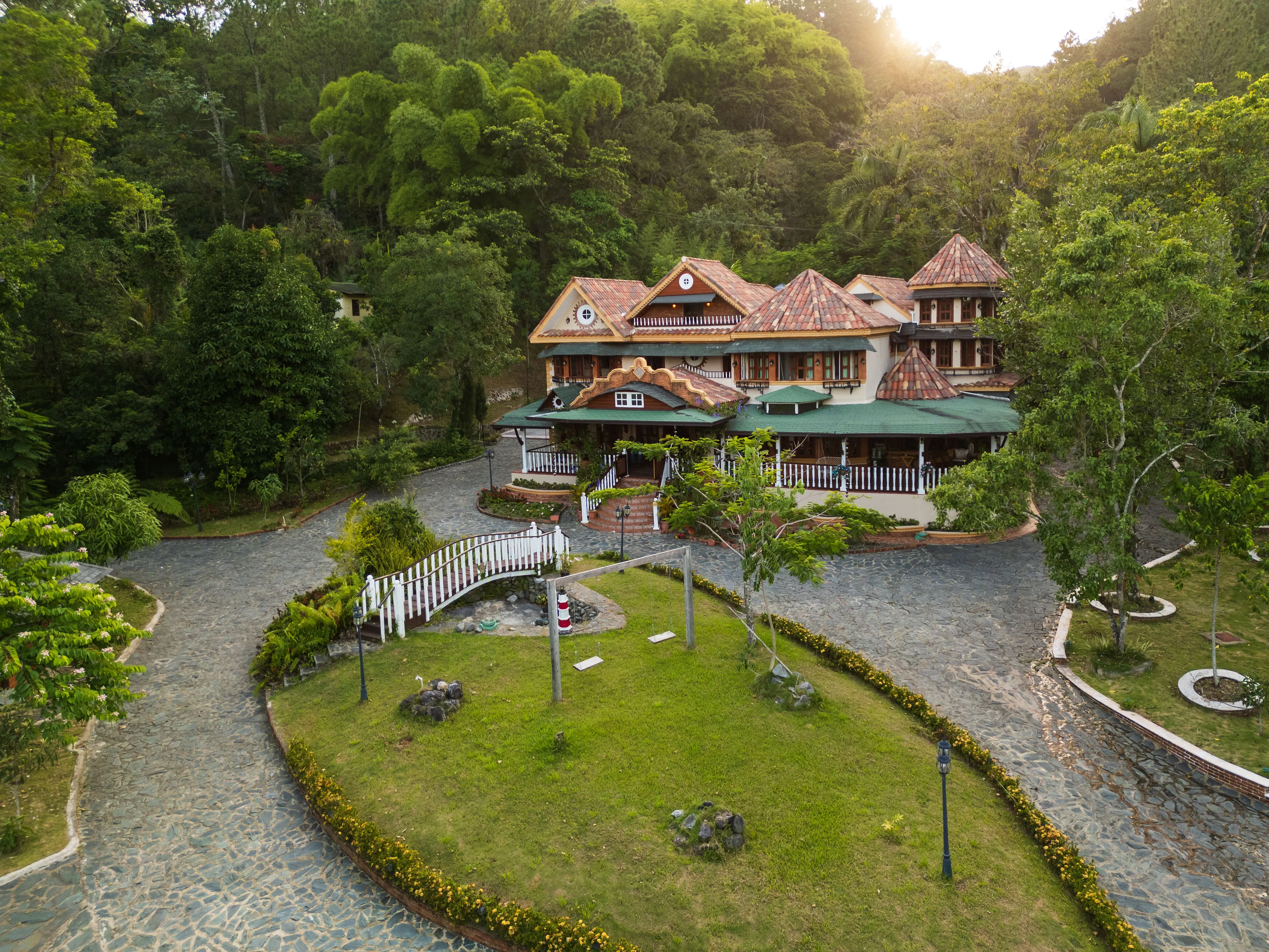 Aerial view of the property and its grounds, surrounded by forested mountains